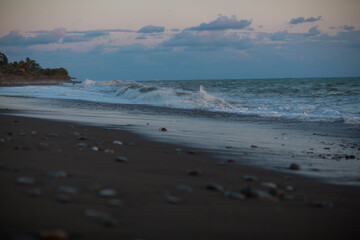 beautiful sunset by the sea with strong waves