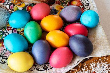 Colorful easter eggs on a table in different color. Red, blue and yellow for decorative egg. 
Tradition and religion in europe. Top view.