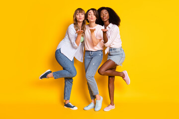 Full body photo of three pretty girls closed eyes hand palm send air kiss camera you isolated on...