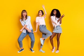 Full size photo of pretty cheerful persons diversity enjoy free time chilling isolated on yellow color background