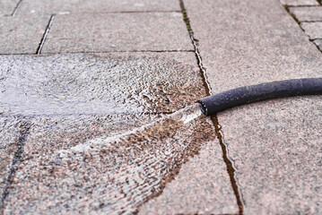 Leaking water from hose on a city street