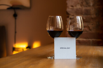Two glasses of wine and paper with the inscription special day.