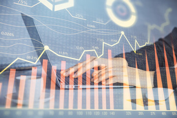 Double exposure of businesswoman hands typing on computer and forex graph hologram drawing. Financial analysis concept.