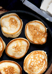 Small banana pancakes on a frying pan