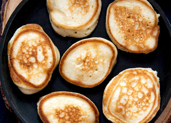 Small pancakes on a frying pan. Close up view