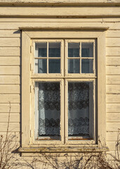 Jugend window of abandoned wooden house.