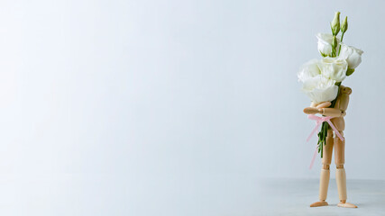 wooden mannequin, doll holding flowers on a light background. Banner, concept for mothers day, womens day, birthday.