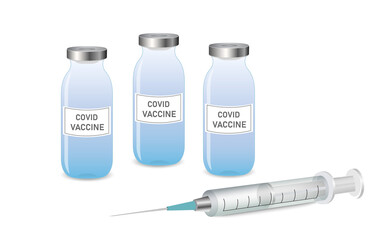 An injection syringe lying on the surface, next to three vials of coronavirus vaccine.