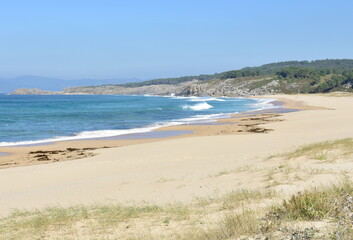 Wild beach with waves breaking, view from sand dunes. Rias Baixas region, Porto do Son, Coruña, Galicia, Spain.