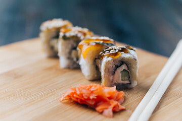 sushi rolls red ginger chopsticks wood board japanese cuisine