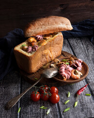 Traditional Icelandic fish soup with salmon and seafood in bread. An unusual pitch. Food Styling