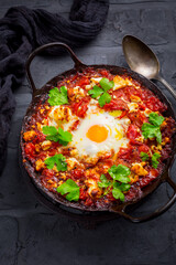 Shakshuka -  dish of eggs poached in a tomato sauce with Feta cheese and coriander