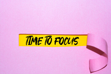 TIME TO FOCUS message written under torn paper.