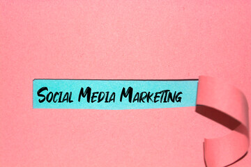 Social Media Marketing concept written behind torn paper