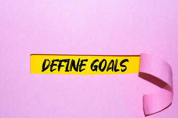DEFINE GOALS word on written behind torn paper.