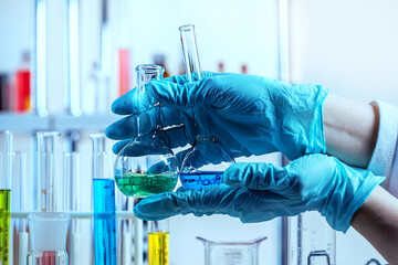 Hand in glove holding test tube