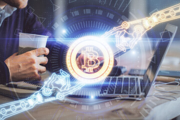 Double exposure of man's hands holding and using a phone and crypto currency blockchain theme drawing.