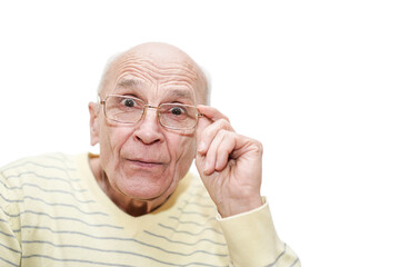 Funny man with wondering look holding glasses in hand and looking.