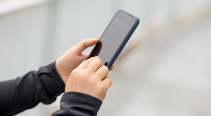 Asian woman using smartphone outdoors