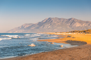The picturesque high waves during the windy morning on the beach of Patara in Turkey. A popular destination for tourists and locals alike
