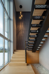 Wooden staircase with illumination in luxury private house. Interior.