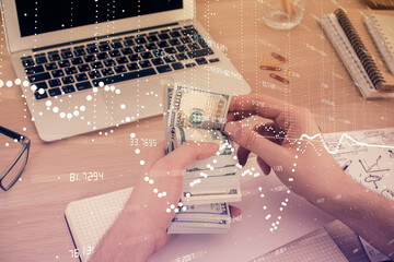 Multi exposure of technology drawing hologram and us dollars bills and man hands. Data concept