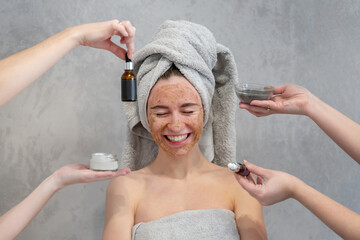 Young happy woman in towel making facial massage with organic face scrub. Girl applying scrub cream, peeling and cleaning skin. Skin Care