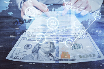 Fototapeta premium Multi exposure of social network theme drawing hologram and USA dollars bills and man hands.