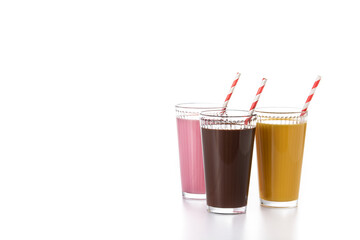 Chocolate, strawberry and vanilla milkshakes isolated on white background. Copy space