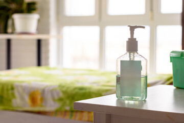 There is a tube of antiseptic on the table against the background of the room