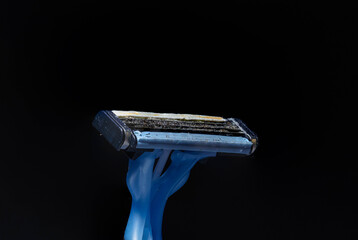 Disposable plastic razor blocked with an accumulation of thick shaving matter