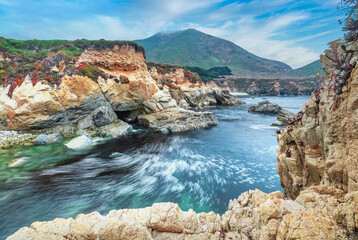 Fototapeta na wymiar Beautiful view of a small rocky cove in the Pacific Ocean, colorful landscape, sea coast along the number one road in California