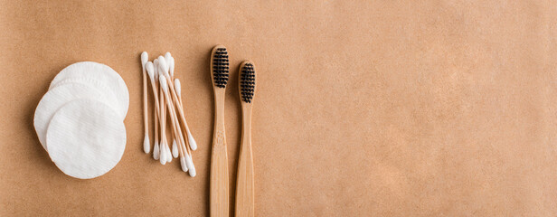 Eco friendly medical cleaning and healthcare accessories. Cotton pads, bamboo ear sticks and charcoal toothbrushes. Banner background © Vladislav Noseek