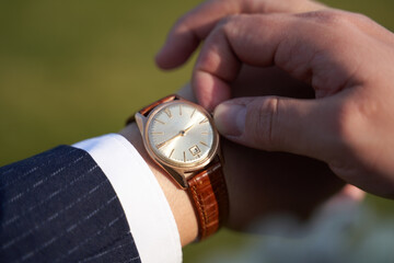 man winds the watch on his hand