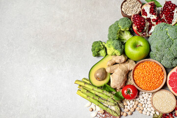 Fresh vegetables, fruits and seeds on grey table, flat lay. Space for text