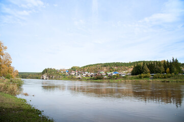 Fototapeta na wymiar village landscape with a river on a warm sunny day