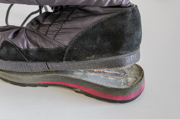 A shoemaker repairs a shoe, showing how the sole of a shoe came off