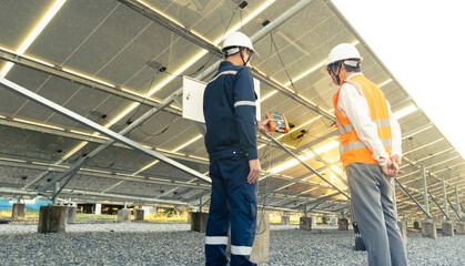 Engineers with investor walk to check the operation of the solar farm(solar panel) systems, Alternative energy to conserve the world is energy, Photovoltaic module idea for clean energy production