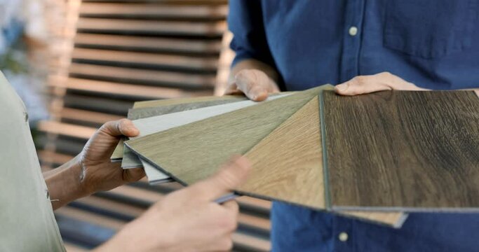 interior design shop salesman showing material samples to customer