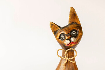 Funny wooden cat on a light background. Close-up.