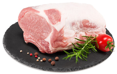 raw pork meat with rosemar, tomato and peppercorn on black round stone plate isolated on white background. Clipping path and full depth of field