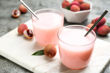 Delicious lychee cocktails and fresh fruits on white marble board