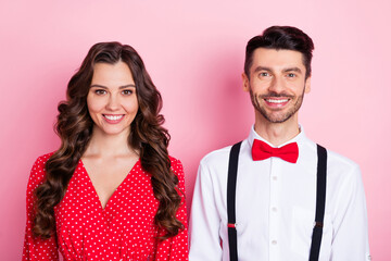 Portrait of nice optimistic brown hair couple she wear dress he shirt isolated on pastel pink color background