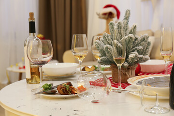 Dirty dishes on white table in room. Mess after new year party