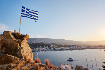 Greek national flag with the sea view. Saronic gulf, Greece, Europe.