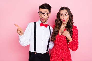 Photo of nice impressed brown hair couple point empty space wear trend cloth isolated on pastel pink color background