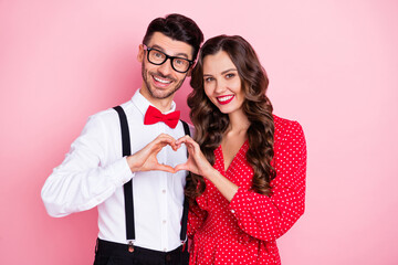 Photo of nice optimistic brown hair couple show heart wear trend cloth isolated on pastel pink color background