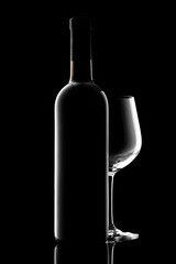 red wine bottle and wine glass isolated on black background