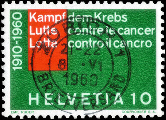 Postage stamp issued in the Switzerland dedicated to the Fight against cancer. Inscription in 3 languages, circa 1960