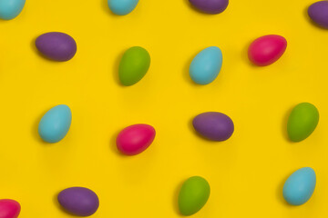 Pattern Of Colored Easter Eggs Isolated on a Yellow Background. Holidays, traditions concept.